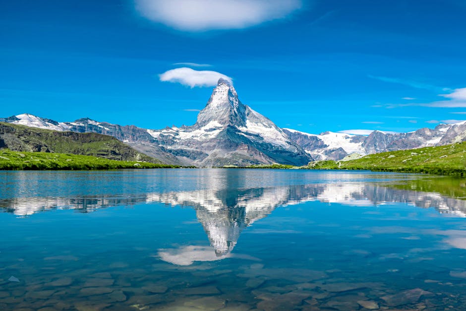 Breathtaking view of the Matterhorn reflecting in a serene Swiss lake under a clear blue sky