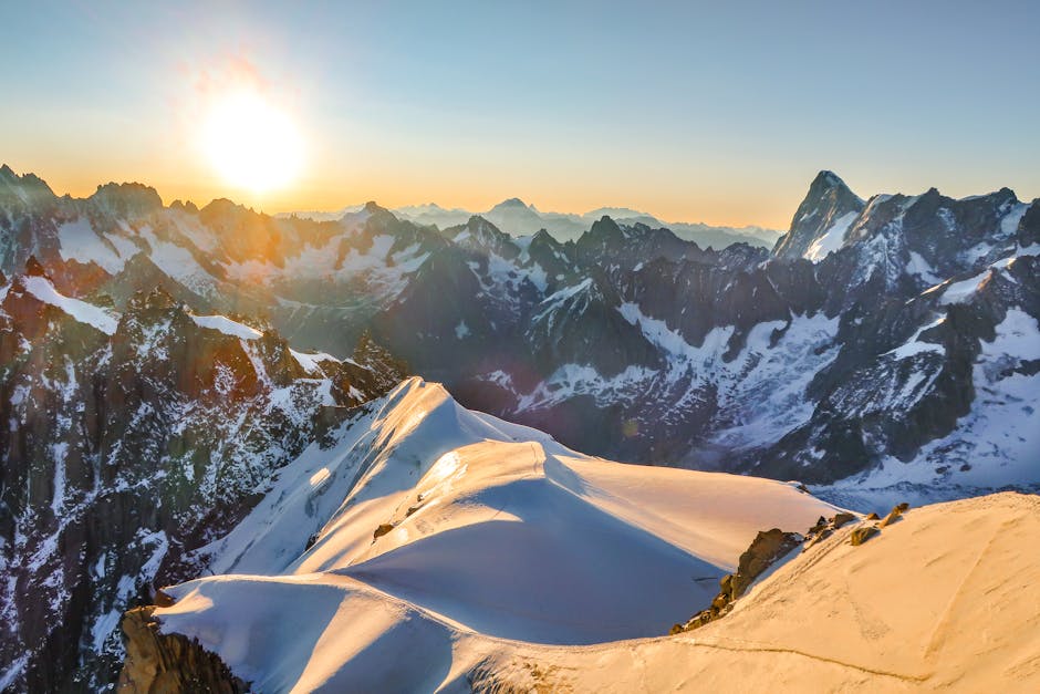 Stunning view of snow-covered Aiguille du Midi peaks at sunset in Chamonix, France