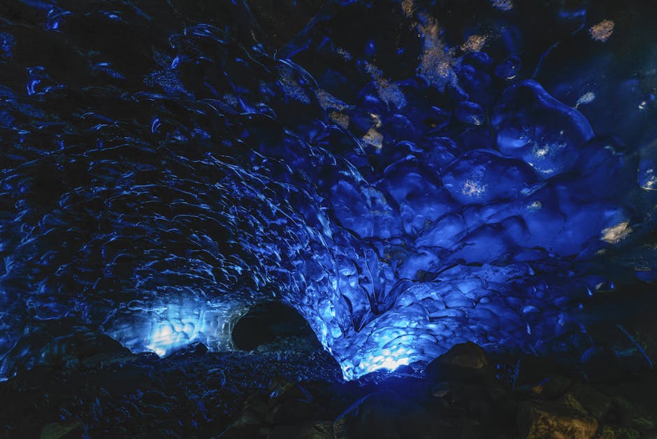 Captivating view inside a naturally lit blue ice cave with textured walls