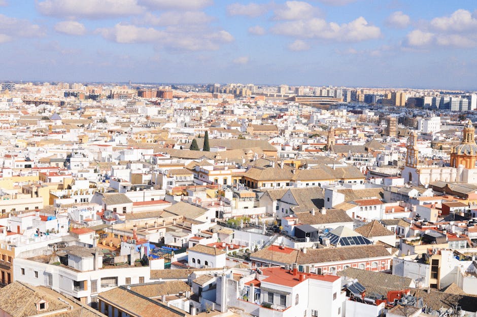 A breathtaking aerial shot showcasing the historic architecture of Seville, Spain under a vibrant sky