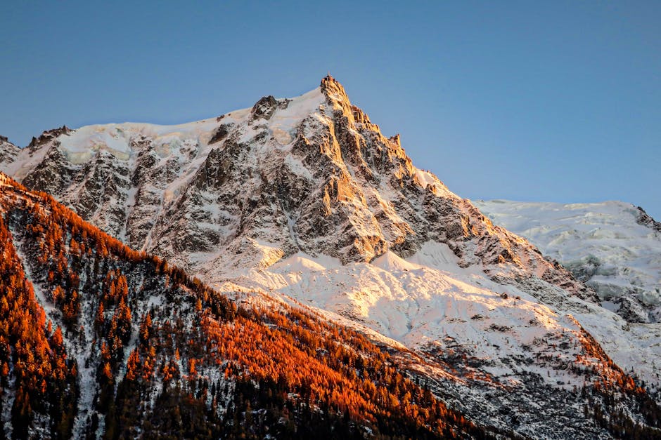 A stunning view of Aiguille du Midi bathed in golden hour light, Chamonix, France