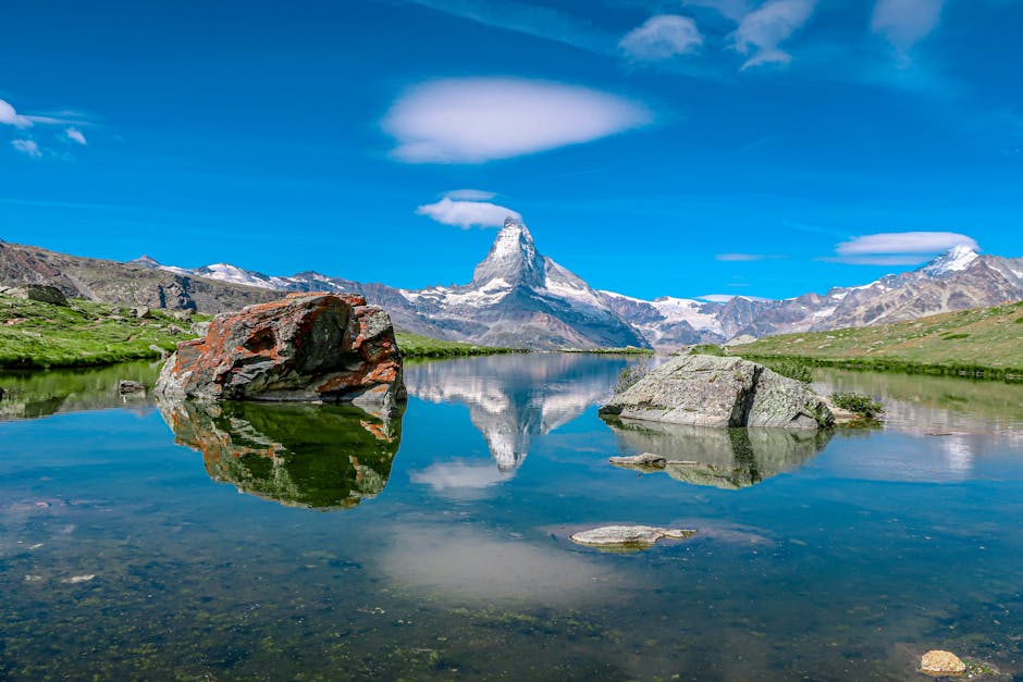 Breathtaking reflection of the Matterhorn mountain in a pristine Swiss alpine lake under clear skies